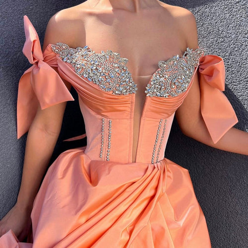 peach and silver dress Fully sequined dress of peach & shimmery silver with a high slit. The  embroidery is hugging the neckline with a playful intertwined criss-cross.  #TonyWardCouture #TonyWardRTWSS24 #TheOtherSideofEden